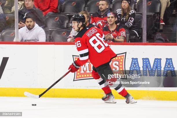 New Jersey Devils center Jack Hughes skates with the puck during a game between the St. Louis Blues and New Jersey Devils on March 7, 2024 at...