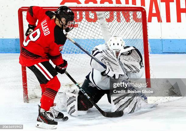 New Hampshire goaltender Sedona Blair makes a save on Northeastern defenseman Kristina Allard in the first period. Northeastern beat UNH, 4-1.