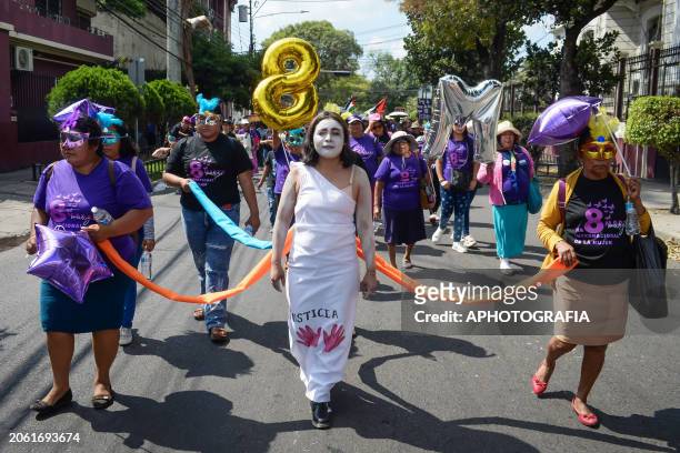 Protestors march painted and using masks during a demonstration for International Women's Day on March 8, 2024 in San Salvador, El Salvador. Every...