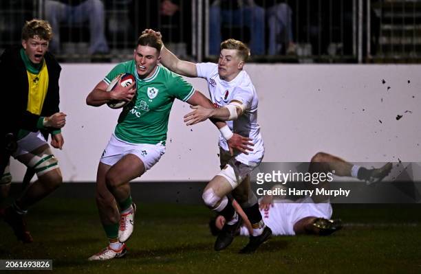 Bath , United Kingdom - 8 March 2024; Finn Treacy of Ireland evades the tackle of Ben Redshaw of England on his way to scoring his side's first try...