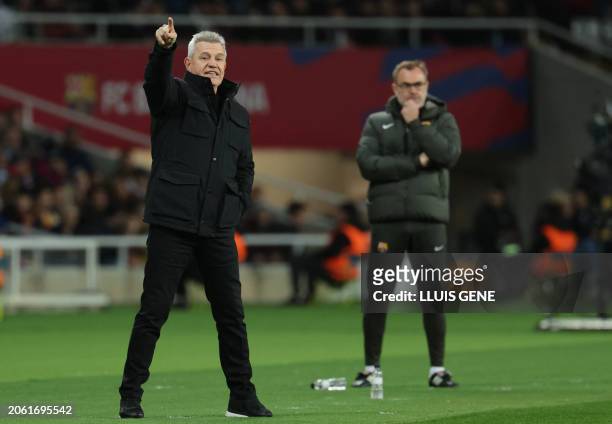 Real Mallorca's Mexican coach Javier Aguirre shouts instructions to his players from the touchline as Barcelona's Spanish assistant coach Oscar...
