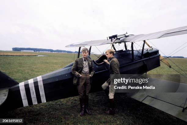 Actors Malcolm McDowell and Peter Firth pose for portraits during an interview on the set of the film, "Aces High," in Wycombe Air Park on September...