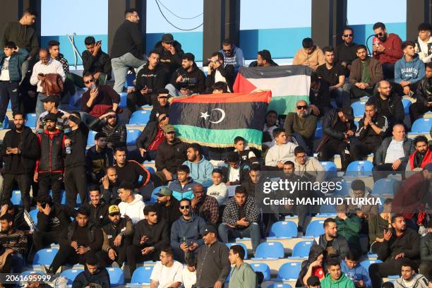 Libyans take their seats ahead of a friendly match between Libya-Africa Legends and AC Milan Legends at the Tripoli International Stadium on March 8...