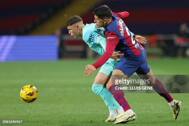 Real Mallorca's Uruguayan defender Giovanni Gonzalez fights for the ball with Barcelona's Portuguese defender Joao Cancelo during the Spanish league...
