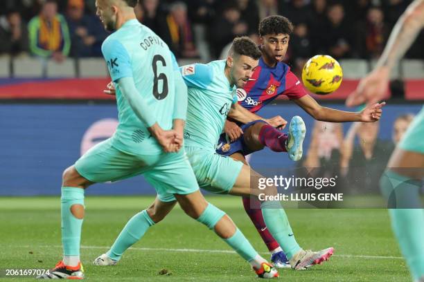 Barcelona's Spanish forward Lamine Yamal kicks the ball to scores his team's first goal during the Spanish league football match between FC Barcelona...