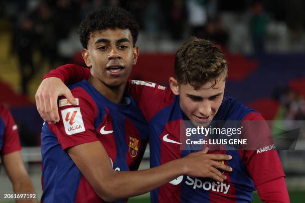 Barcelona's Spanish forward Lamine Yamal celebrates with Barcelona's Spanish midfielder Fermin Lopez after scoring his team's first goal during the...