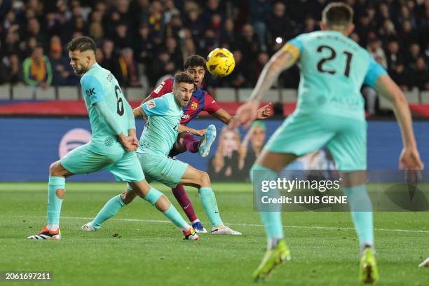 Barcelona's Spanish forward Lamine Yamal kicks the ball to scores his team's first goal during the Spanish league football match between FC Barcelona...