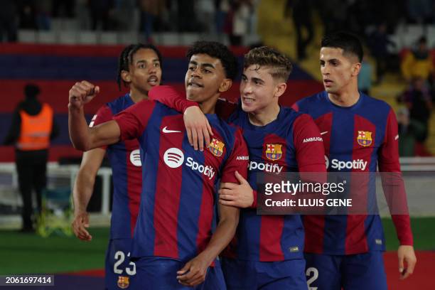 Barcelona's Spanish forward Lamine Yamal celebrates with teammates after scoring his team's first goal during the Spanish league football match...