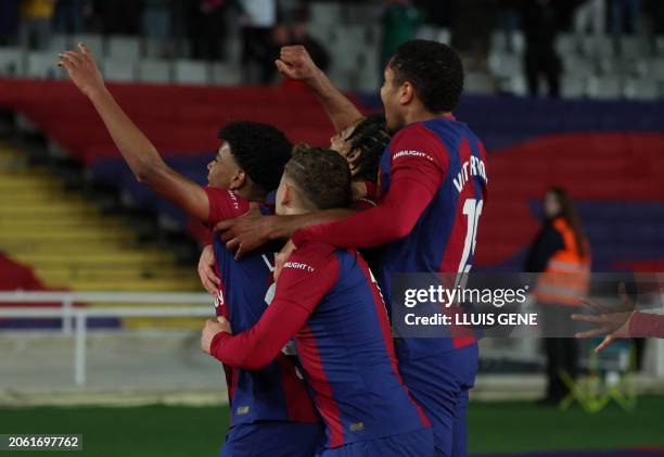 Barcelona's Spanish forward Lamine Yamal celebrates with teammates after scoring his team's first goal during the Spanish league football match...