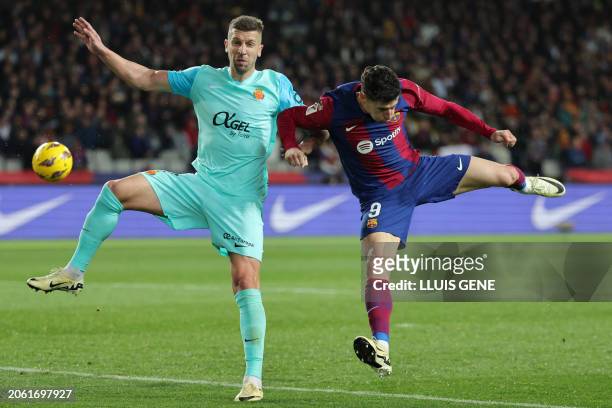 Real Mallorca's Serbian defender Matija Nastasic fights for the ball with Barcelona's Polish forward Robert Lewandowski during the Spanish league...