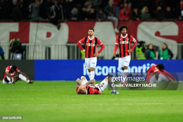 Nice's players react at the end of the French L1 football match between OGC Nice and Montpellier Herault SC at the Allianz Riviera Stadium in Nice,...