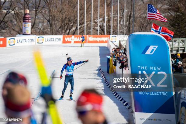 Jake Brown of the United States points to the crowd as he nears the finish line during the men's 4x7.5-km relay event of the IBU Biathlon World Cup...