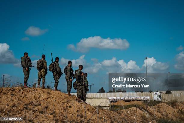 Israeli security forces stand guard as protesters from the Tsav 9 movement, or known as Order 9, attempt to block the border crossing with the goal...