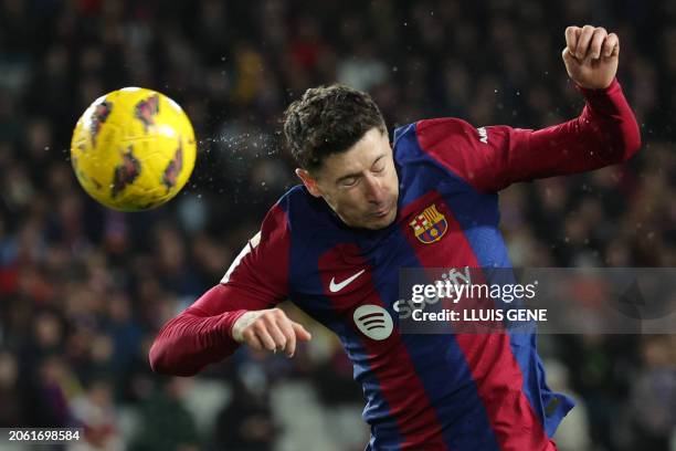 Barcelona's Polish forward Robert Lewandowski heads the ball during the Spanish league football match between FC Barcelona and RCD Mallorca at the...