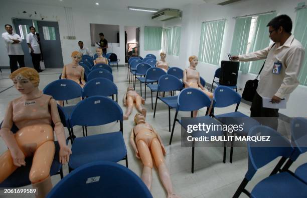 An investigator takes photos of the mannequins as they reconstruct the positions of Hong Kong tourist victims who were killed in the botched bus...