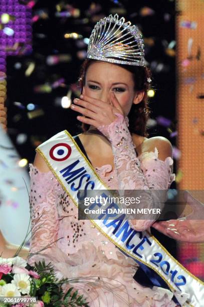 Miss Alsace Delphine Wespiser reacts after being crowned Miss France 2012 during the 65th edition of the beauty contest in the western city of Brest...