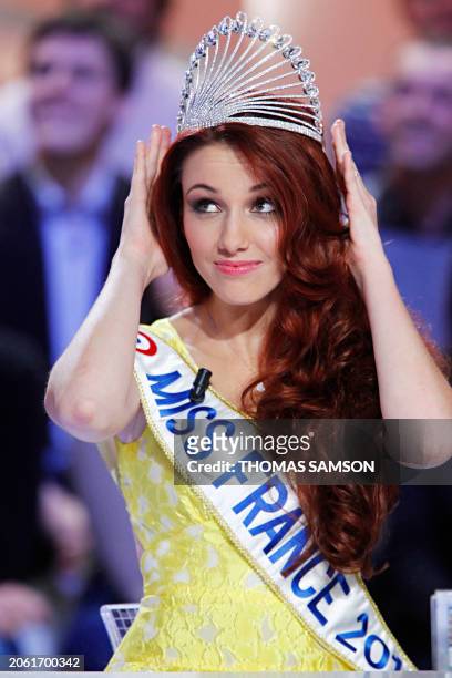 Newly crowned Miss France 2012, Delphine Wespiser puts her crown on her head as she takes part in the TV show "Le Grand Journal" at the French TV...