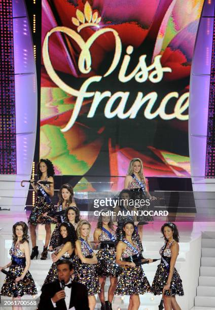 French TV host Jean-Pierre Foucault speaks next to contenders during the 62nd Miss France beauty contest, on December 6 2008 in Le Puy-du-Fou, west...