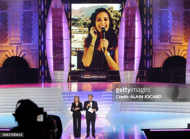 Miss France 2008 Valerie Begue appears on a giant screen as French TV host Jean-Pierre Foucault speaks during the 62nd Miss France beauty contest, on...