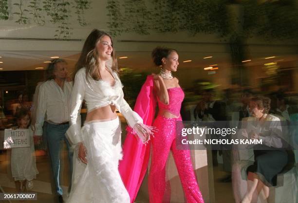 Miss Dominican Republic 2000 Gilda Jovine and Miss France 2000 Sonia Rolland walk out together at the end of a Miss Universe 2000 fashion show in...