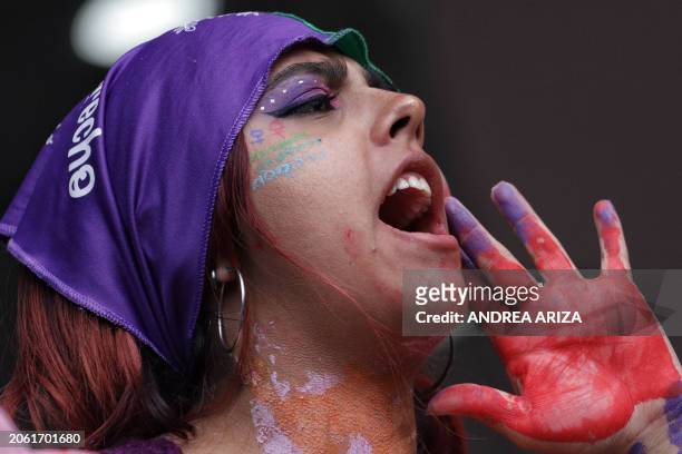 Demonstrator shouts slogans during a protest to mark International Women's Day in Bogota, on March 8, 2024. People around the world marked...