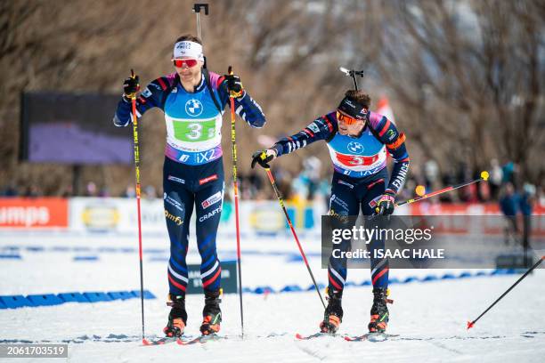 France's Fabien Claude tags his teammate Emilien Jacquelin during the men's 4x7.5-km relay of the IBU Biathlon World Cup at Soldier Hollow Nordic...