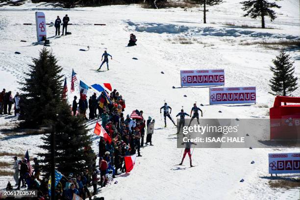 Athletes climb up a hill during the men's 4x7.5-km relay of the IBU Biathlon World Cup at Soldier Hollow Nordic Center in Midway, Utah, on March 8,...