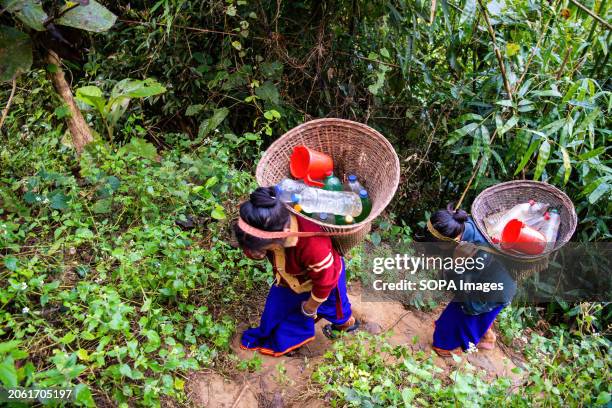 Mro children return home after fetching drinking water from a mountain spring. Mro people are an indigenous ethnic group in Bangladesh. They...