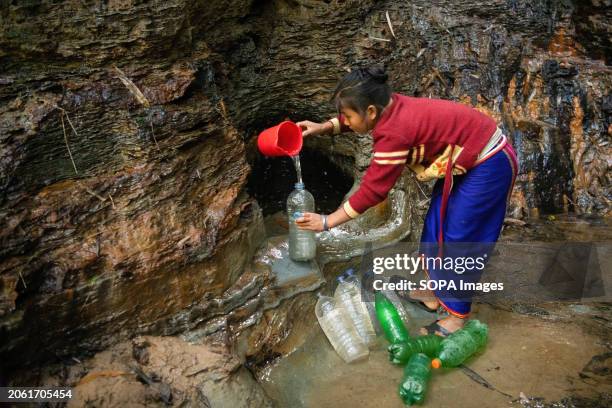 Mro woman fetches drinking water from a mountain spring. Mro people are an indigenous ethnic group in Bangladesh. They primarily inhabit the...