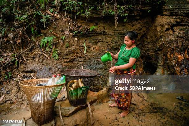 Mro woman fetches drinking water from a mountain spring. Mro people are an indigenous ethnic group in Bangladesh. They primarily inhabit the...