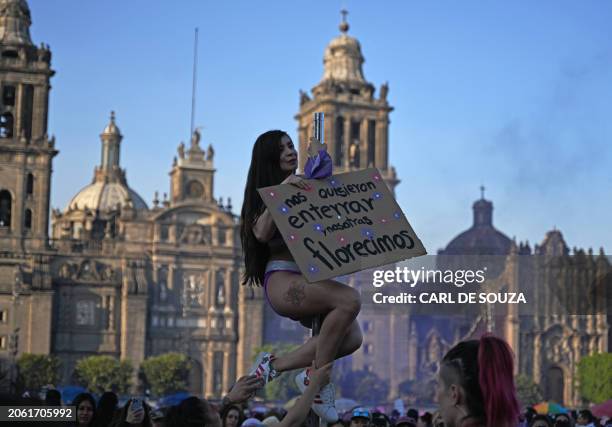 Protestor holds a sign during a protest to mark International Women's Day in Mexico City, on March 8, 2024.