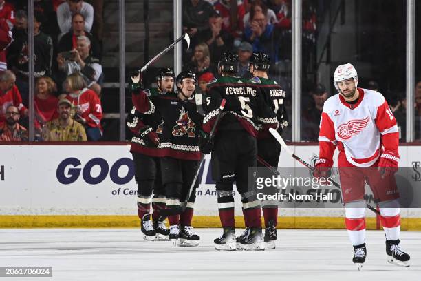 Nick Bjugstad of the Arizona Coyotes celebrates with Michael Kesselring, Clayton Keller and teammates after scoring a goal against the Detroit Red...