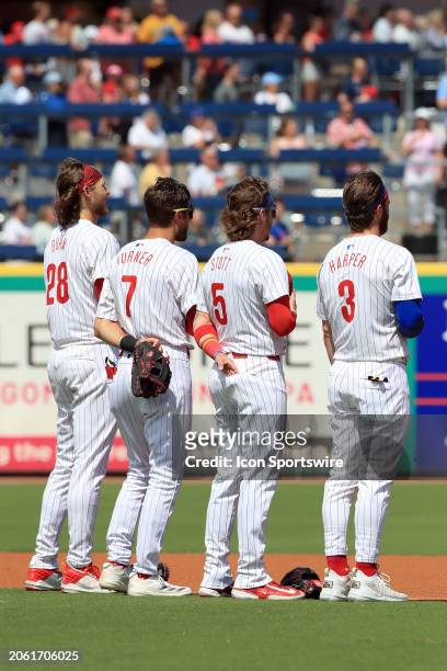 Philadelphia Phillies infielders Alec Bohm , Trea Turner , Bryson Stott and Bryce Harper listen to the playing of the National Anthem before the...