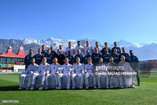 England's players and staff members pose for a group photo before the start of the third day of the fifth and last Test cricket match between India...