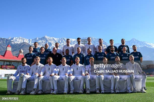 England's players and staff members pose for a group photo before the start of the third day of the fifth and last Test cricket match between India...