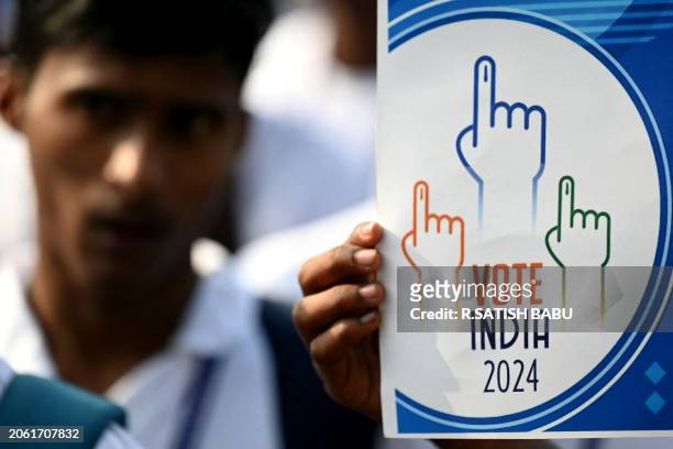 Students holding a placard take part in a rally to create awareness about the importance of voting, ahead of the upcoming general elections, in...