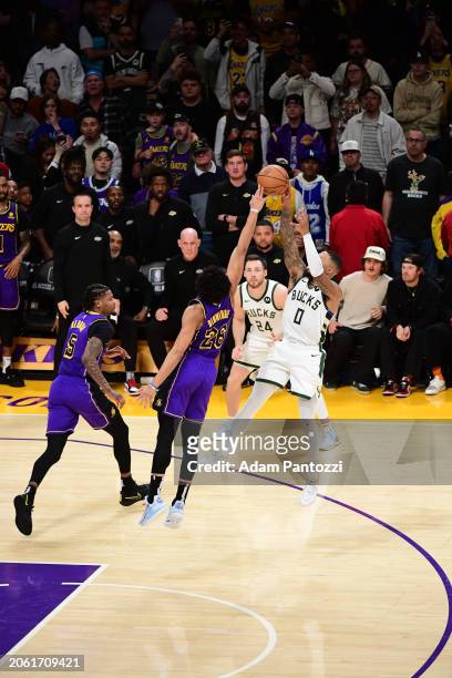 Spencer Dinwiddie of the Los Angeles Lakers blocks the shot by Damian Lillard of the Milwaukee Bucks on March 8, 2024 at Crypto.Com Arena in Los...