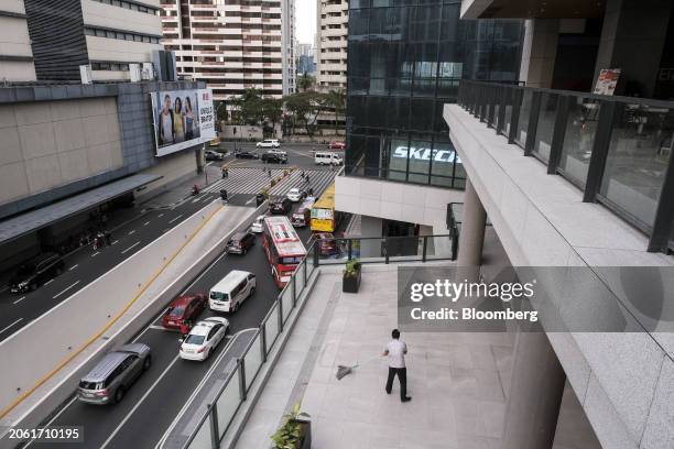 Maintenance staff mops the floor of a mall in Ayala Center in the central business district in Makati City, Metro Manila, the Philippines, on...