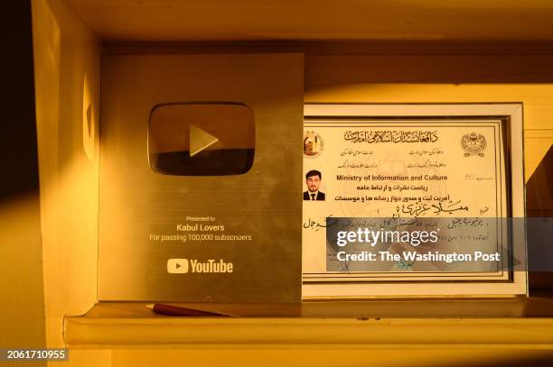 Milad Azizi displays his broadcasting license and an award in the office from which he runs "Kabul Lovers", one of Afghanistan's most successful...