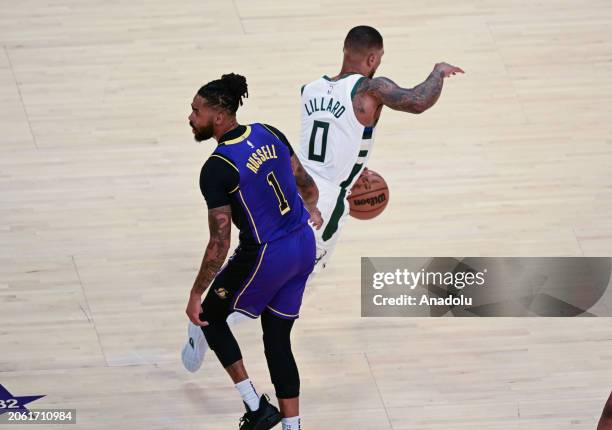 Damian Lillard of Milwaukee Bucks in action against D'Angelo Russell of Los Angeles Lakers during NBA game between Milwaukee Bucks and Los Angeles...