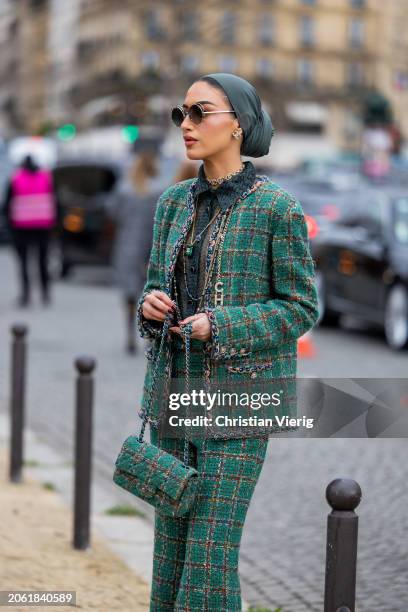 Guest wears green head scarf, blazer, flared pants, bag outside Chanel during the Womenswear Fall/Winter 2024/2025 as part of Paris Fashion Week on...