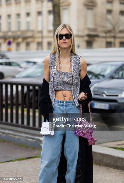 Linda Tol wears denim jeans, grey cropped top, vest, pink bag outside Chanel during the Womenswear Fall/Winter 2024/2025 as part of Paris Fashion...