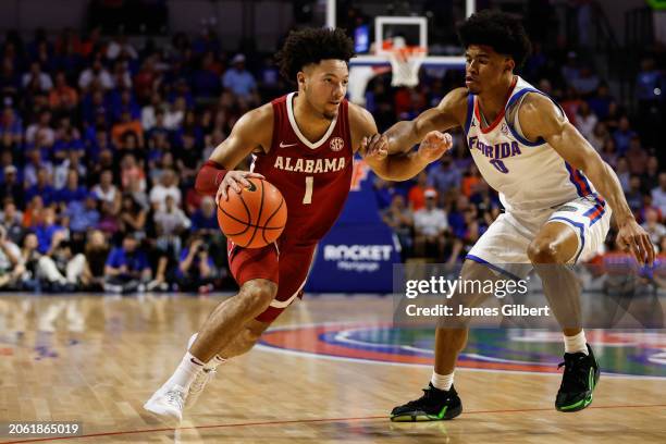 Mark Sears of the Alabama Crimson Tide dribbles the ball against Zyon Pullin of the Florida Gators during the first half of a game at the Stephen C....