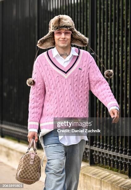 Guest is seen wearing a Lacoste pink sweater, white button down shirt, light blue jeans and tan Gucci bag outside the Lacoste show during the...