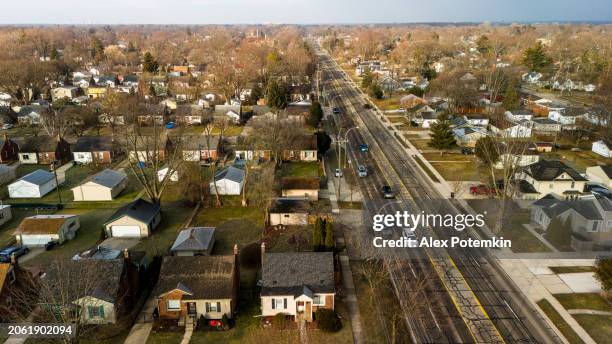 car traffic moving through the royal oak neighborhood in michigan in sunny spring day - royal oak michigan stock pictures, royalty-free photos & images