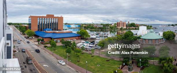 waterfront road passes by a marina on hampton river in hampton, va. - view of hampton bridge stock pictures, royalty-free photos & images