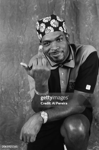 Rapper Luther Campbell of the group 2 Live Crew sticks up his middle finger in an obscene gesture and wears a Miami Marlins polo shirt when he...