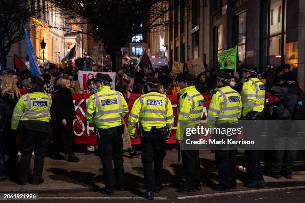 Metropolitan Police officers stand in front of Feminists for Palestine close to Charing Cross Police Station during a Feminist Strike for Liberation...