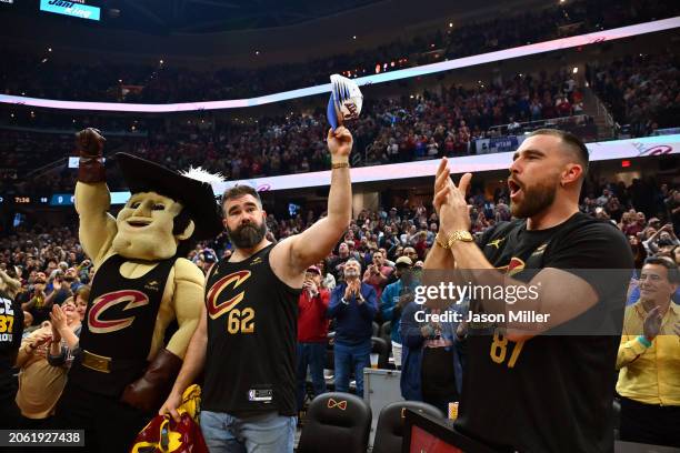 Jason Kelce and Travis Kelce wave to the fans during the first quarter of the game between the Cleveland Cavaliers and the Boston Celtics at Rocket...