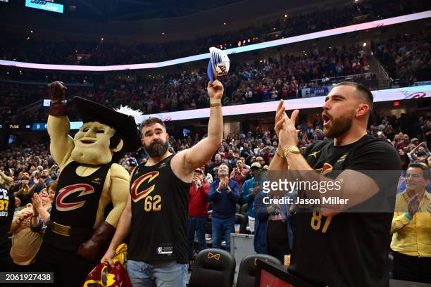 Jason Kelce and Travis Kelce wave to the fans during the first quarter of the game between the Cleveland Cavaliers and the Boston Celtics at Rocket...